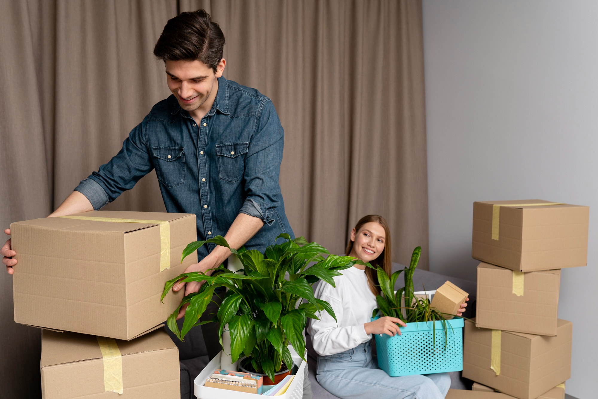 couple-handling-boxes-belongings-after-moving-new-house